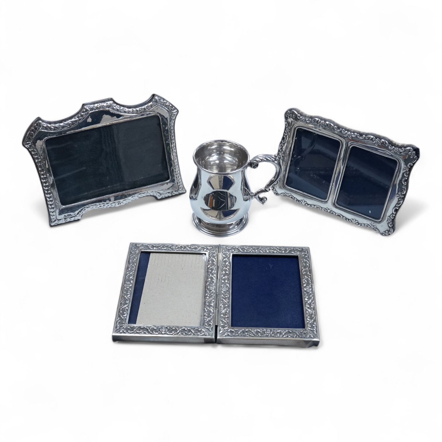 An Elizabeth II silver baluster christening mug, Wakely & Wheeler, London, 1965, with engraved inscription to the base, 10cm, together with two modern silver mounted photograph frames including a double and one other met